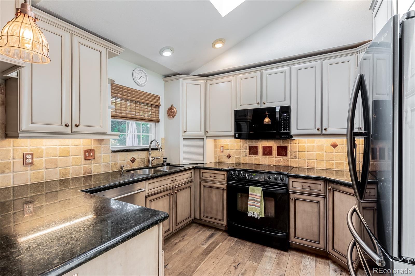 200 East Caley Avenue Centennial, CO 80121 - Photo 10 of 49 a kitchen with stainless steel appliances granite countertop a sink stove microwave and refrigerator