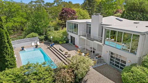 an aerial view of a house with a yard