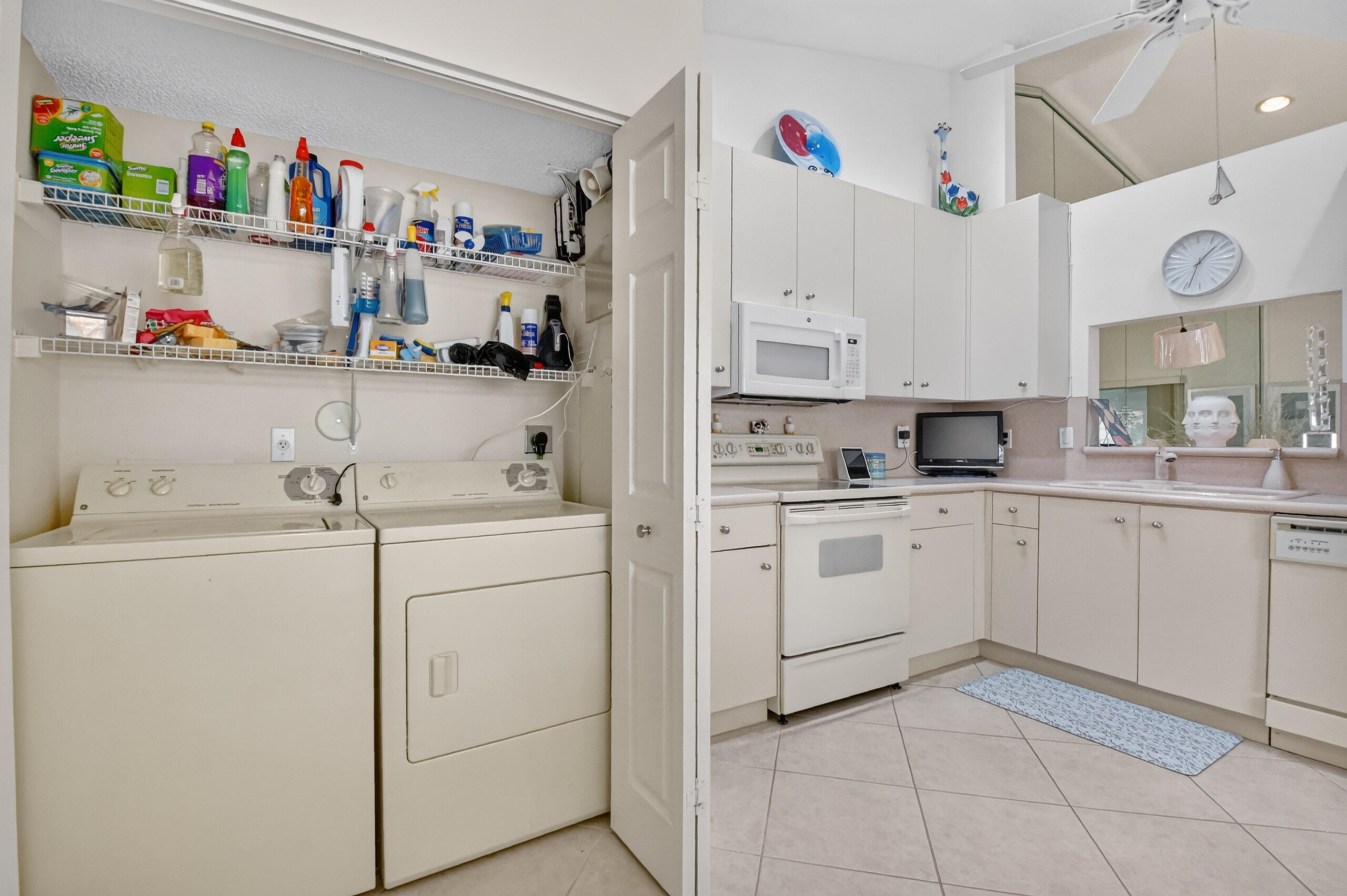 15340 Floral Club Road Delray Beach, FL 33484 - Photo 14 of 42 a kitchen with white cabinets and white appliances