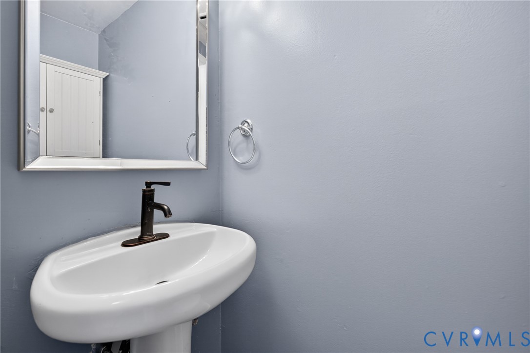 10050 Purcell Road Richmond, VA 23228 - Photo 7 of 26 a bathroom with a sink and mirror