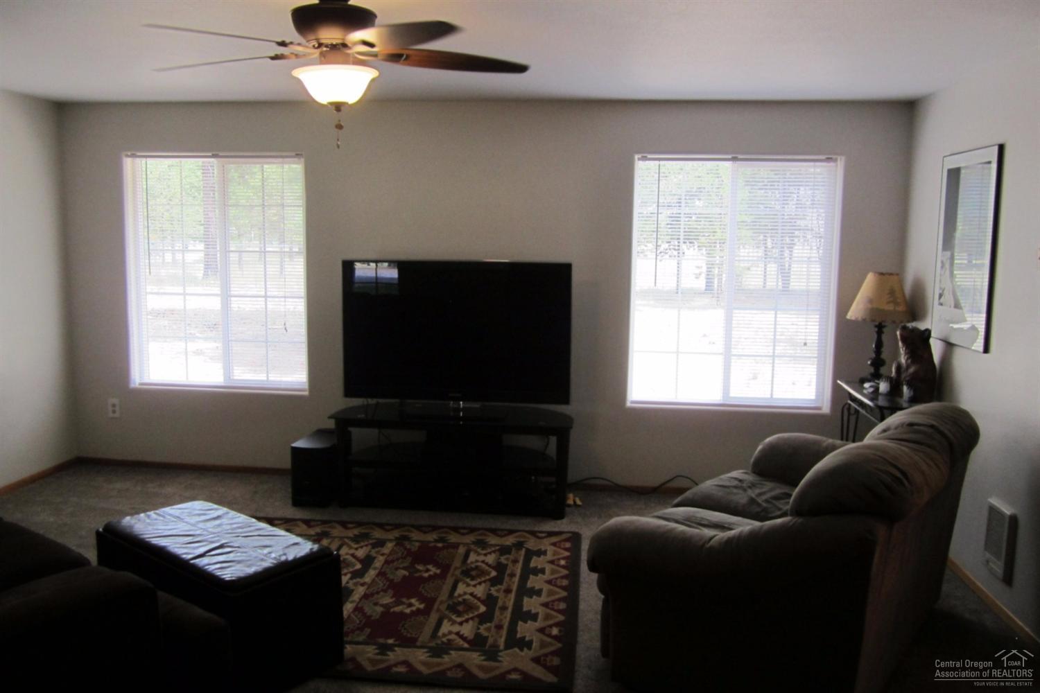 17533 Rosland Road La Pine, OR 97739 - Photo 13 of 25 a living room with furniture a window and a flat screen tv