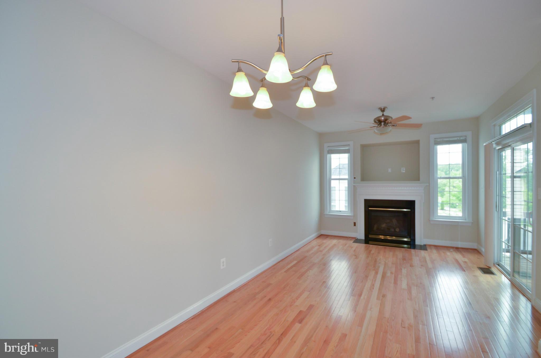 8306 Merlot Lane, Unit 137 Laurel, MD 20723 - Photo 12 of 30 a view of an empty room with wooden floor fireplace and a window