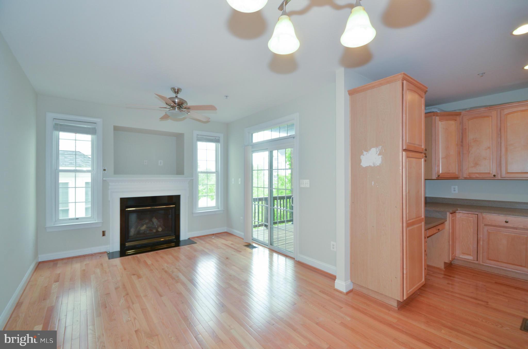 8306 Merlot Lane, Unit 137 Laurel, MD 20723 - Photo 13 of 30 a view of empty room with wooden floor and fireplace