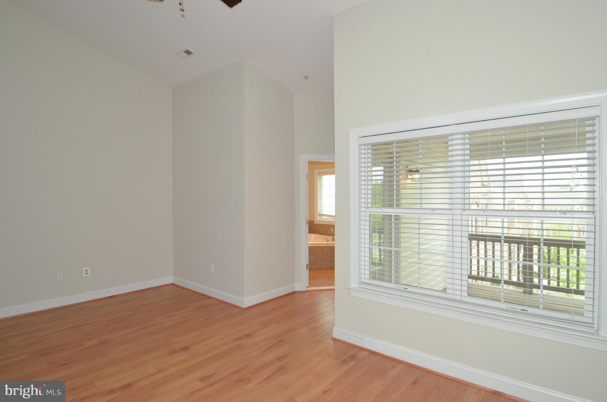 8306 Merlot Lane, Unit 137 Laurel, MD 20723 - Photo 16 of 30 a view of empty room with wooden floor and fan
