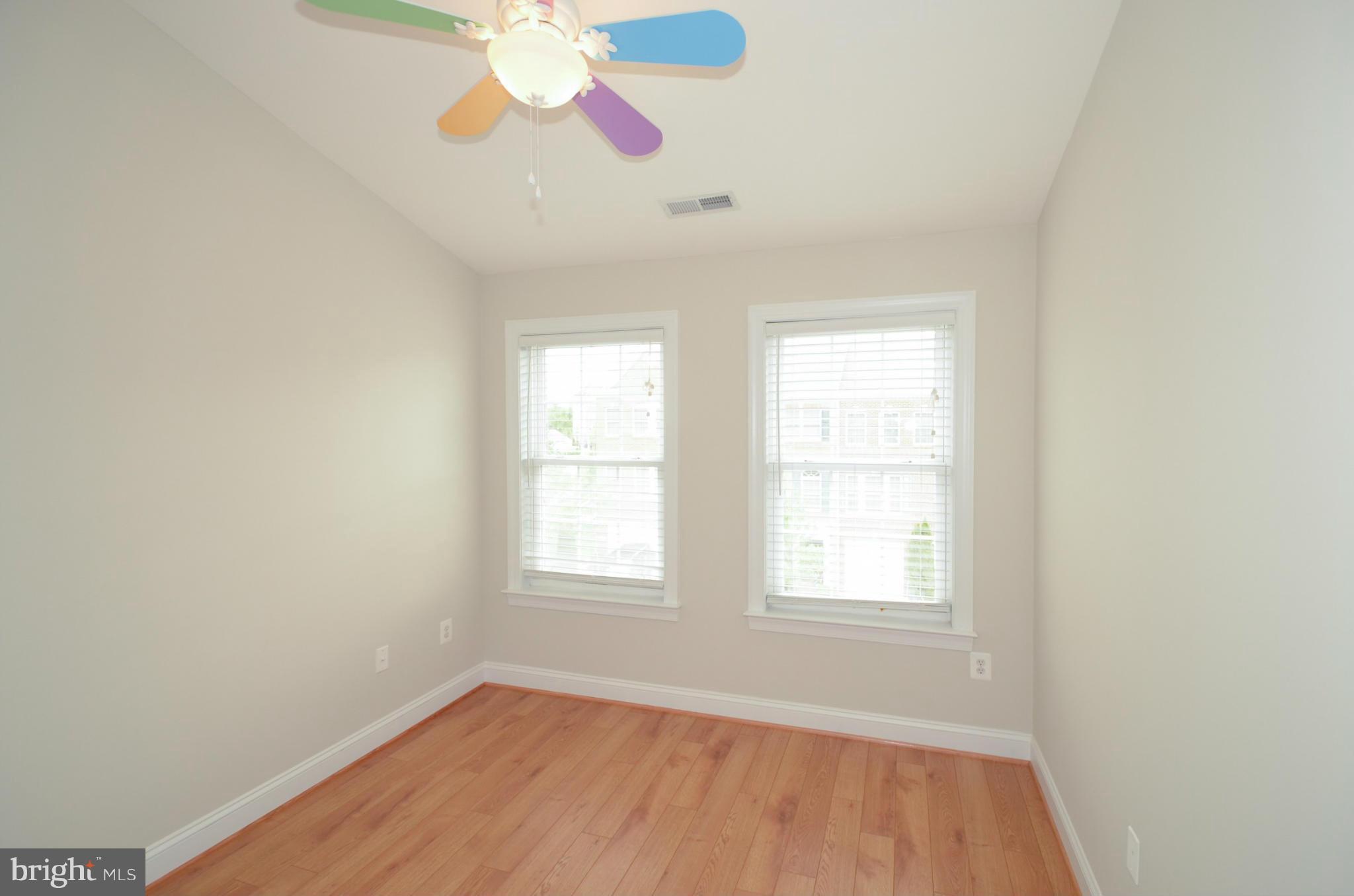 8306 Merlot Lane, Unit 137 Laurel, MD 20723 - Photo 21 of 30 an empty room with a window and a chandelier fan
