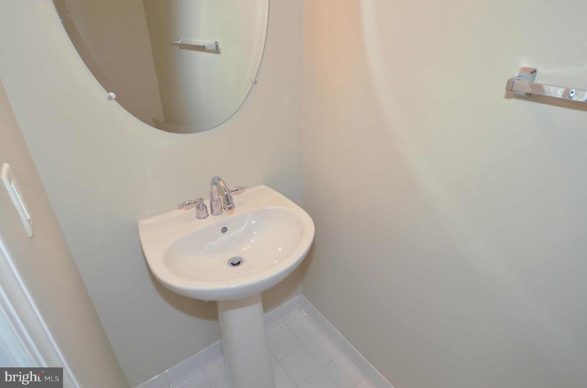 8306 Merlot Lane, Unit 137 Laurel, MD 20723 - Photo 23 of 30 a bathroom with a sink and a mirror
