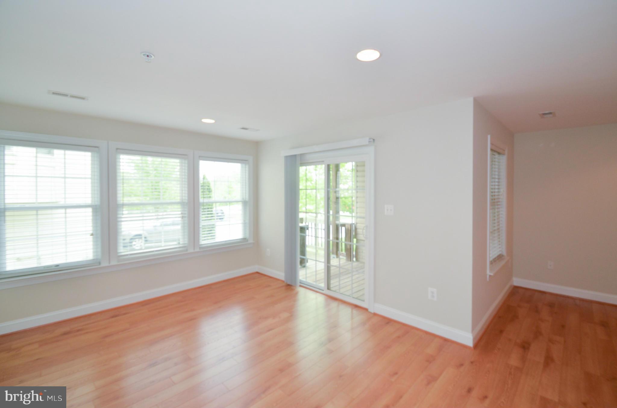8306 Merlot Lane, Unit 137 Laurel, MD 20723 - Photo 25 of 30 an empty room with wooden floor and windows