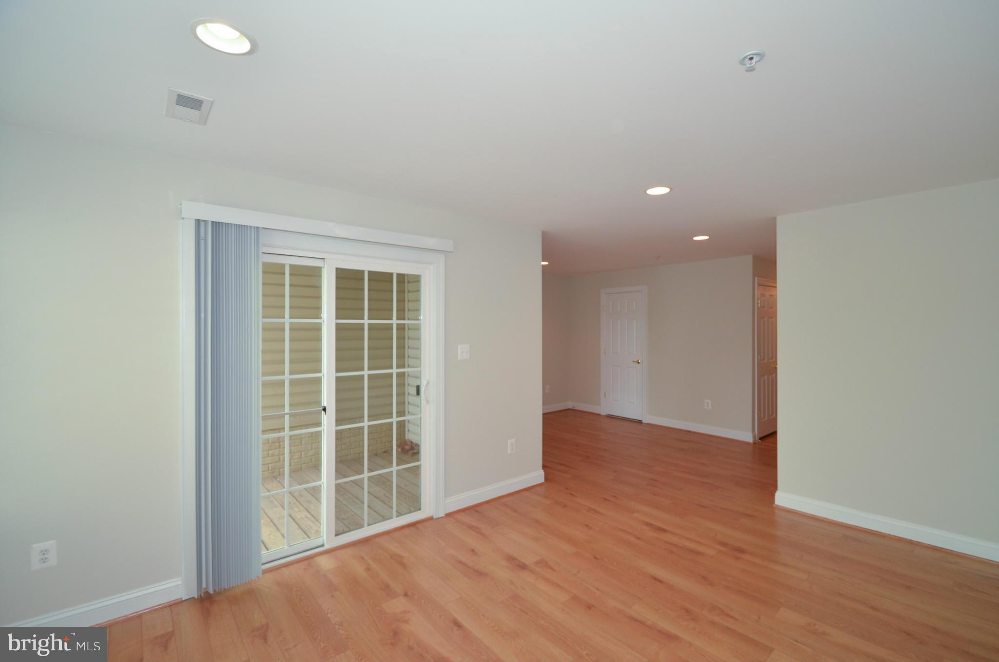 8306 Merlot Lane, Unit 137 Laurel, MD 20723 - Photo 26 of 30 an empty room with wooden floor and windows