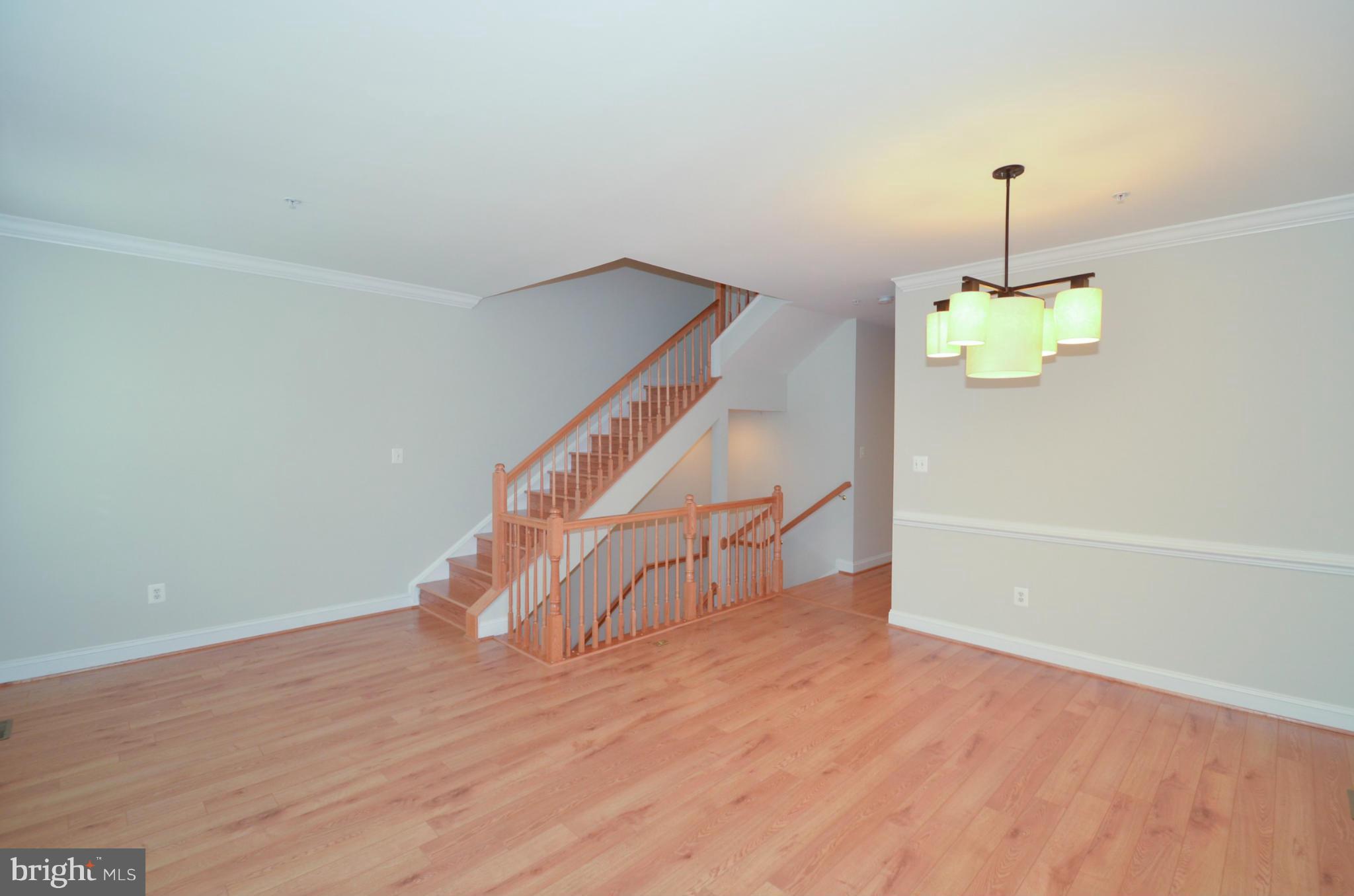 8306 Merlot Lane, Unit 137 Laurel, MD 20723 - Photo 5 of 30 a view of an empty room with wooden floor and a window