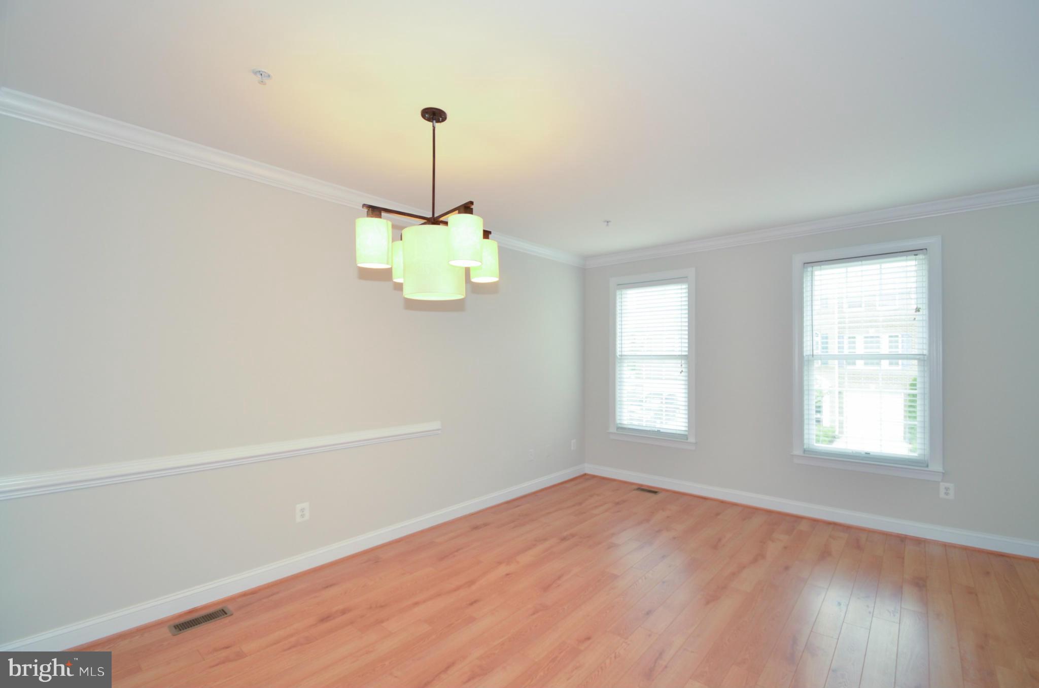 8306 Merlot Lane, Unit 137 Laurel, MD 20723 - Photo 6 of 30 a view of an empty room with a window and wooden floor