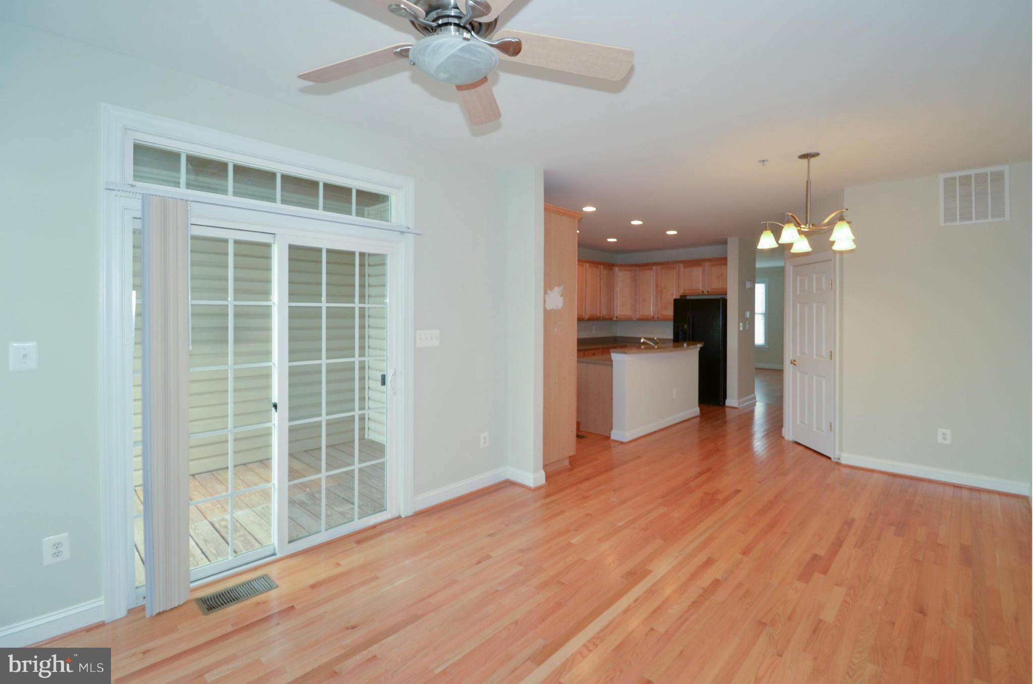 8306 Merlot Lane, Unit 137 Laurel, MD 20723 - Photo 7 of 30 a view of a big room with wooden floor and a kitchen