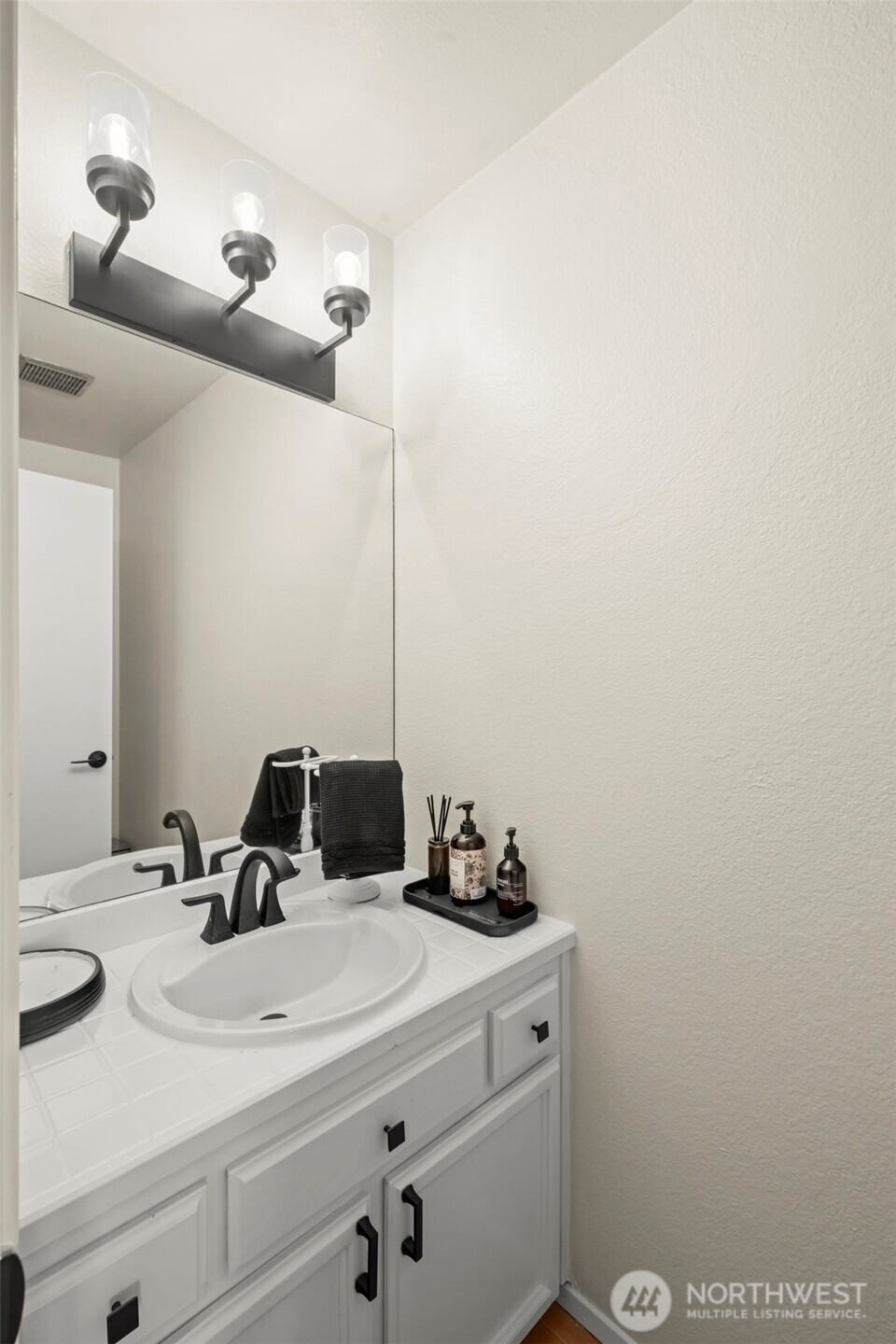 5615 114th Street Southwest Mukilteo, WA 98275 - Photo 25 of 38 a bathroom with a sink and a mirror