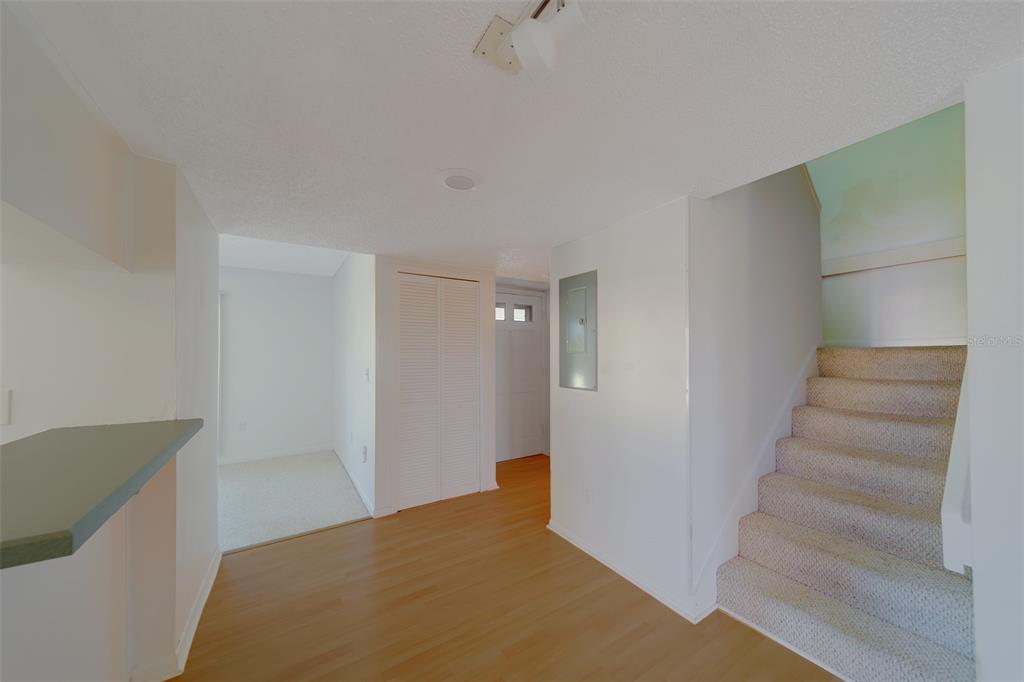 1 Windrush Boulevard, Unit 28 Indian Rocks Beach, FL 33785 - Photo 2 of 68 a view of an empty room with stairs