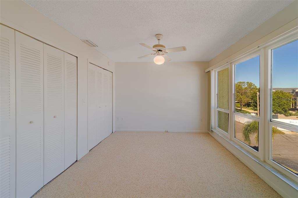 1 Windrush Boulevard, Unit 28 Indian Rocks Beach, FL 33785 - Photo 23 of 68 an empty room with a empty space and windows