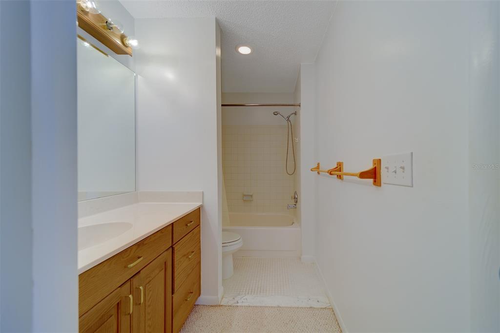 1 Windrush Boulevard, Unit 28 Indian Rocks Beach, FL 33785 - Photo 26 of 68 a bathroom with a shower and a sink