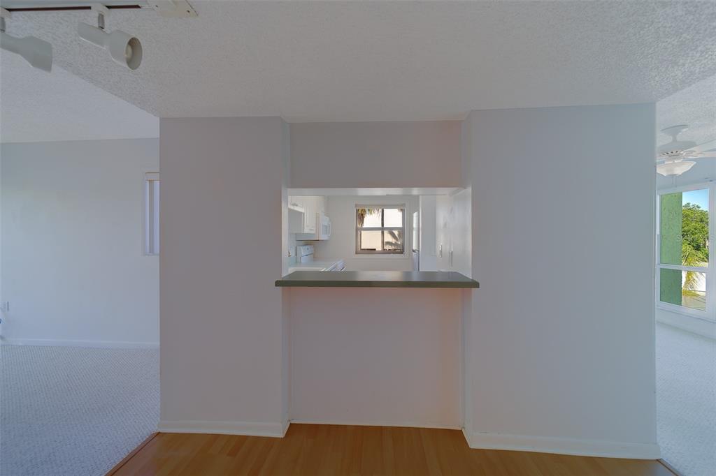 1 Windrush Boulevard, Unit 28 Indian Rocks Beach, FL 33785 - Photo 29 of 68 a view of a livingroom with wooden floor and a window