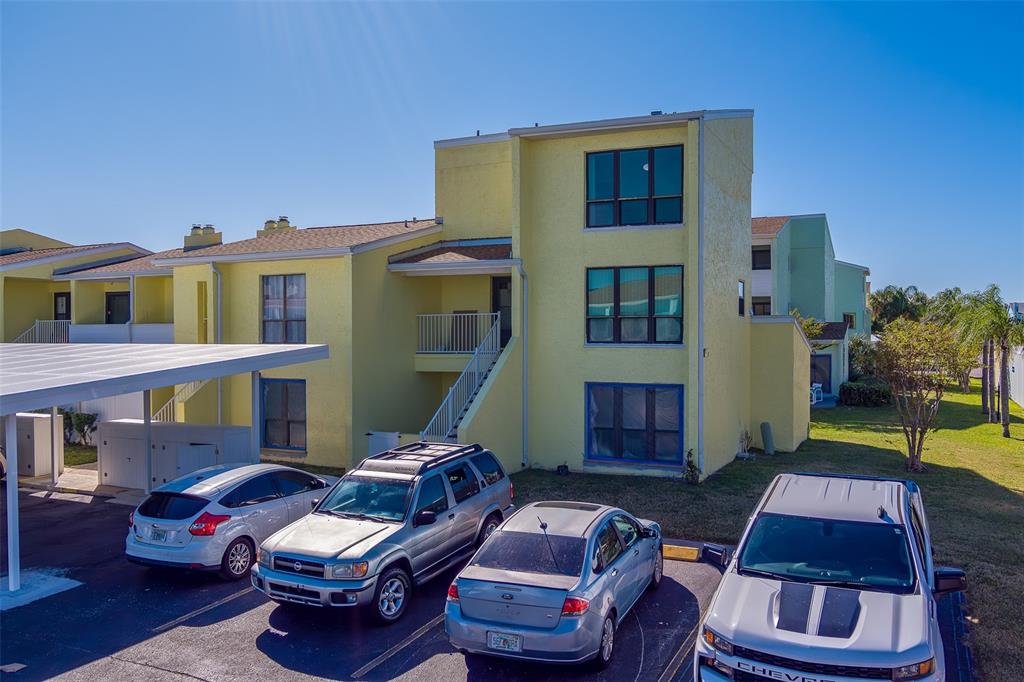 1 Windrush Boulevard, Unit 28 Indian Rocks Beach, FL 33785 - Photo 42 of 68 a backyard of a house with yard fire pit and outdoor seating