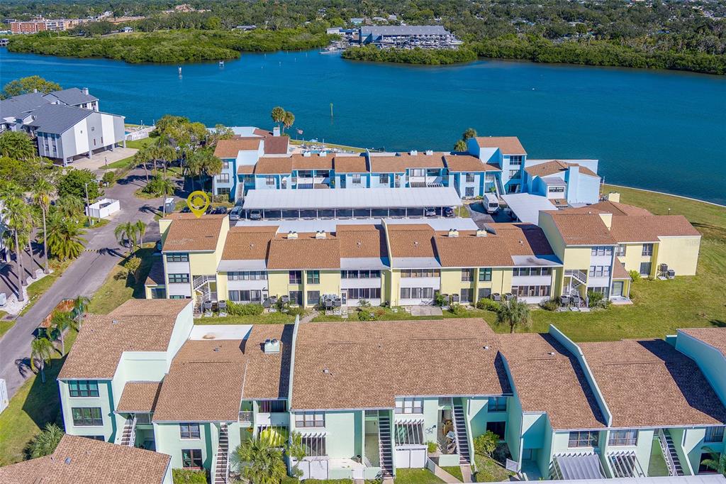 1 Windrush Boulevard, Unit 28 Indian Rocks Beach, FL 33785 - Photo 46 of 68 an aerial view of multiple houses with yard