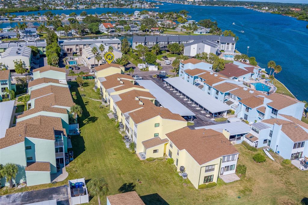 1 Windrush Boulevard, Unit 28 Indian Rocks Beach, FL 33785 - Photo 47 of 68 an aerial view of a residential apartment building with a yard