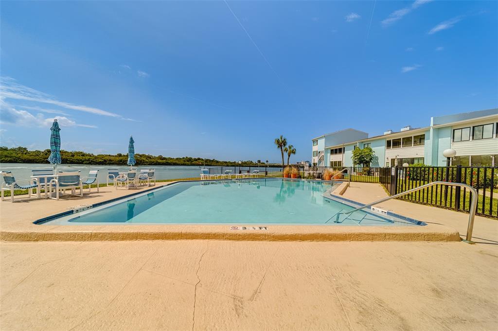 1 Windrush Boulevard, Unit 28 Indian Rocks Beach, FL 33785 - Photo 56 of 68 a view of a swimming pool and an outdoor space