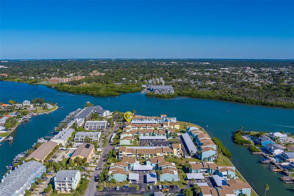 1 Windrush Boulevard, Unit 28 Indian Rocks Beach, FL 33785 - Photo 66 of 68 an aerial view of a city with lots of residential buildings ocean and mountain view in back