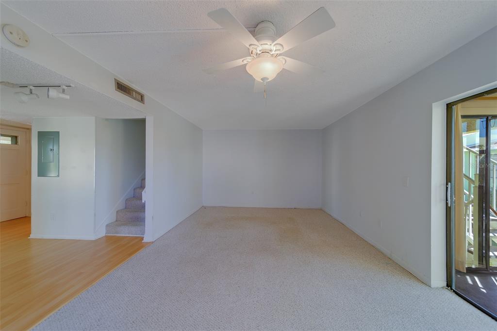 1 Windrush Boulevard, Unit 28 Indian Rocks Beach, FL 33785 - Photo 8 of 68 an empty room with a ceiling fan and a window