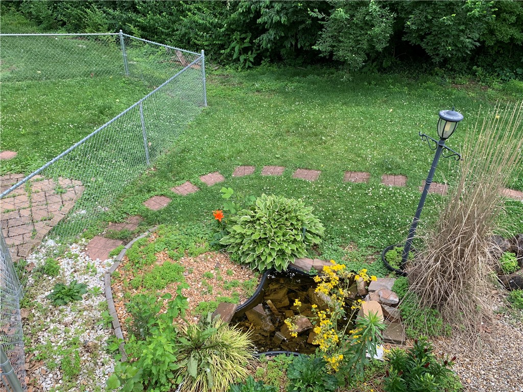 26 Sandcreek Drive Decatur, IL 62521 - Photo 15 of 29 a backyard of a house with lots of green space and garden