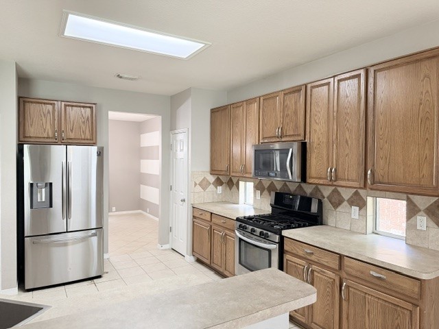 20030 Castlegreen Drive Spring, TX 77388 - Photo 5 of 23 a kitchen with stainless steel appliances granite countertop a refrigerator stove microwave and sink