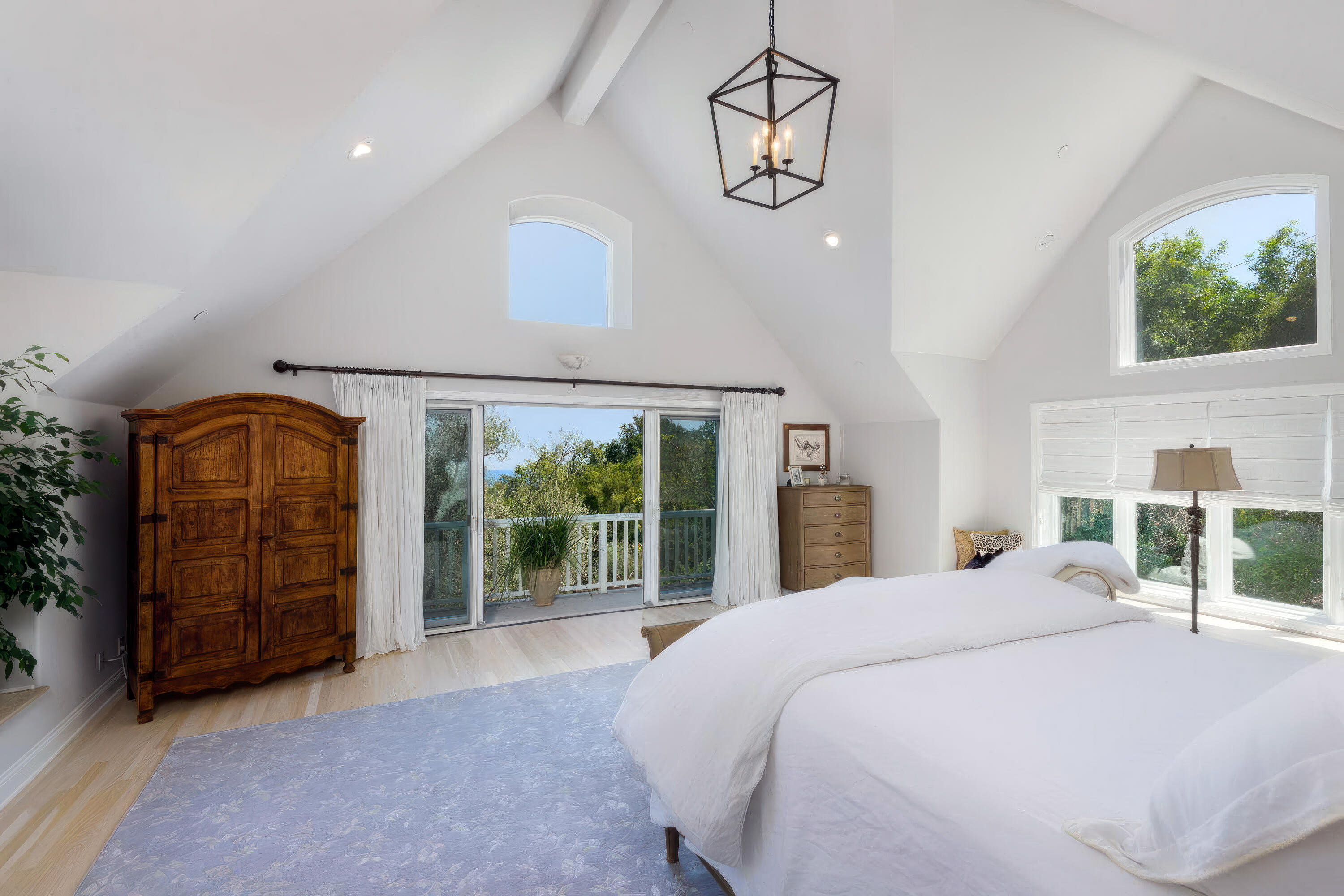 2850 Torito Road Santa Barbara, CA 93108 - Photo 7 of 18 a bedroom with a large bed and a chandelier