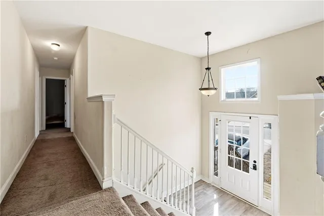a view of a hallway with windows and entryway