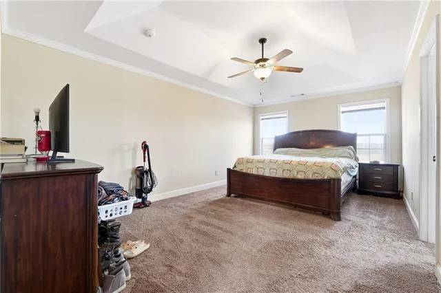a spacious bedroom with a bed and a chandelier