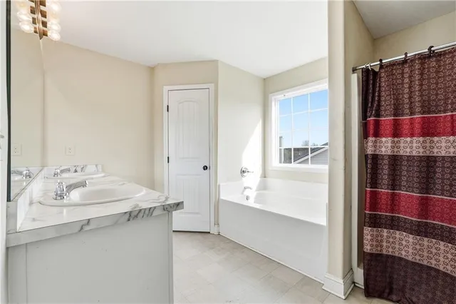 a bathroom with a bathtub and a shower