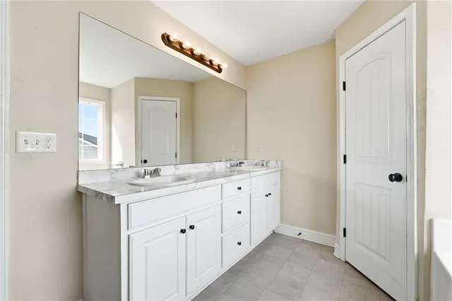 a bathroom with double sink and mirror