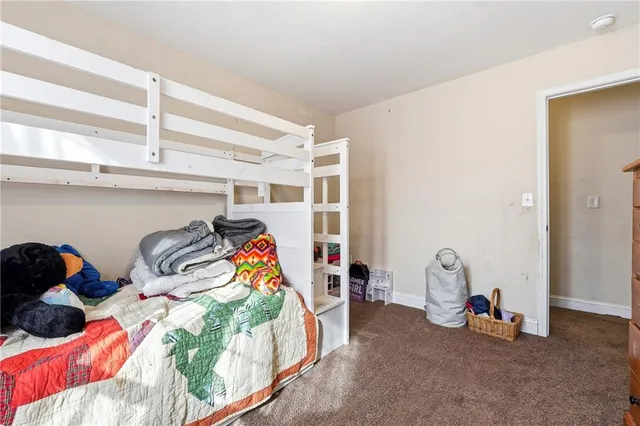 a bedroom with two beds and a window