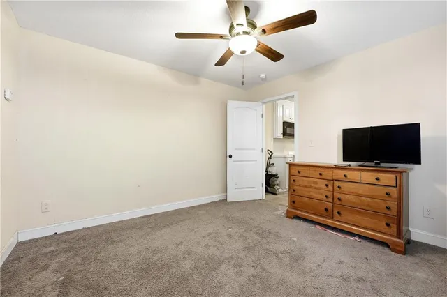 an empty room with furniture and flat screen tv
