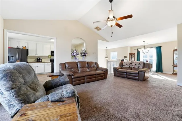 a living room with furniture and a chandelier
