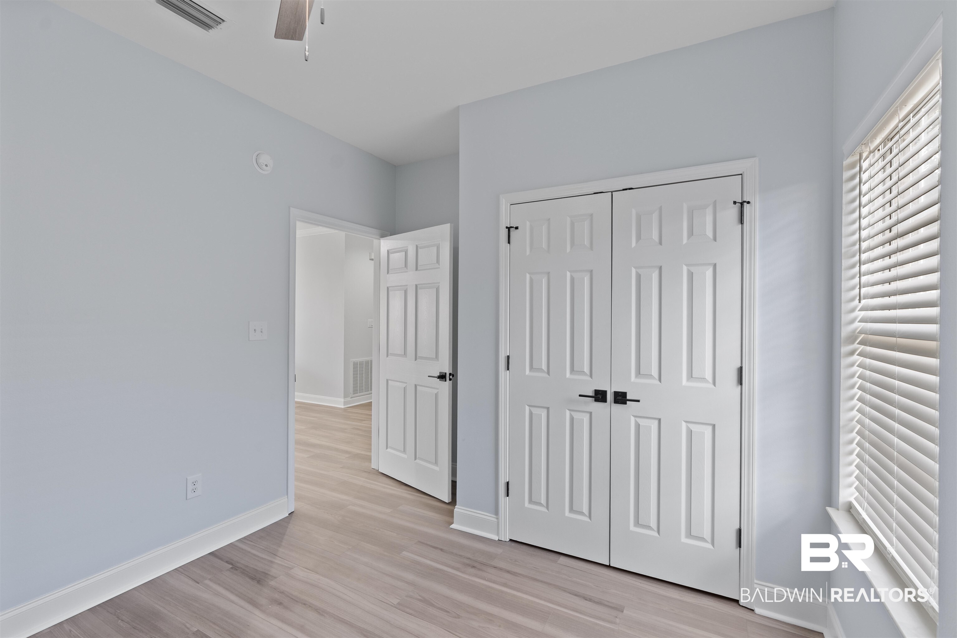 14947 Silveroaks Loop Silverhill, AL 36576 - Photo 23 of 24 Unfurnished bedroom featuring light wood finished floors, a ceiling fan, and a closet