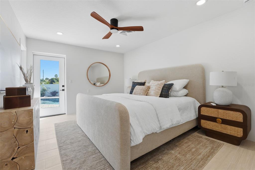 501 65th Street Holmes Beach, FL 34217 - Photo 29 of 61 a bedroom with a bed and a chandelier