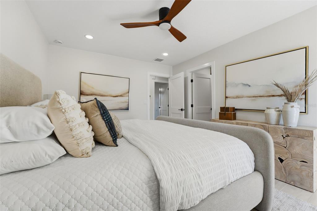 501 65th Street Holmes Beach, FL 34217 - Photo 30 of 61 a large bed sitting in a bedroom and view of bathroom