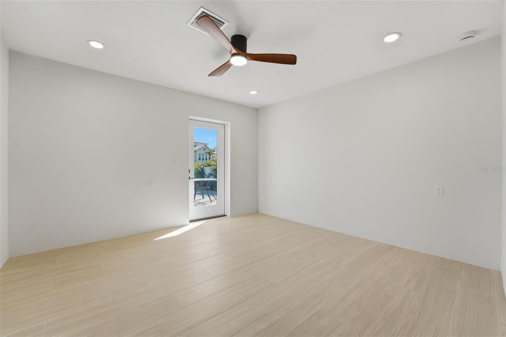 501 65th Street Holmes Beach, FL 34217 - Photo 34 of 61 an empty room with ceiling fan and window
