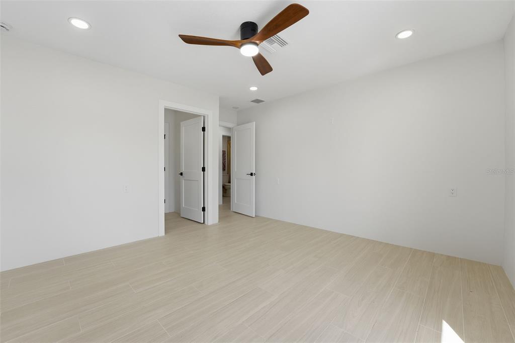 501 65th Street Holmes Beach, FL 34217 - Photo 35 of 61 an empty room with ceiling fan and window