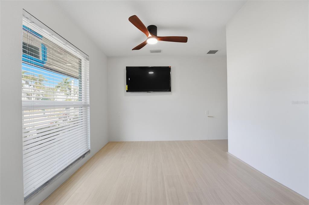 501 65th Street Holmes Beach, FL 34217 - Photo 39 of 61 a view of a livingroom with a ceiling fan and wooden floor
