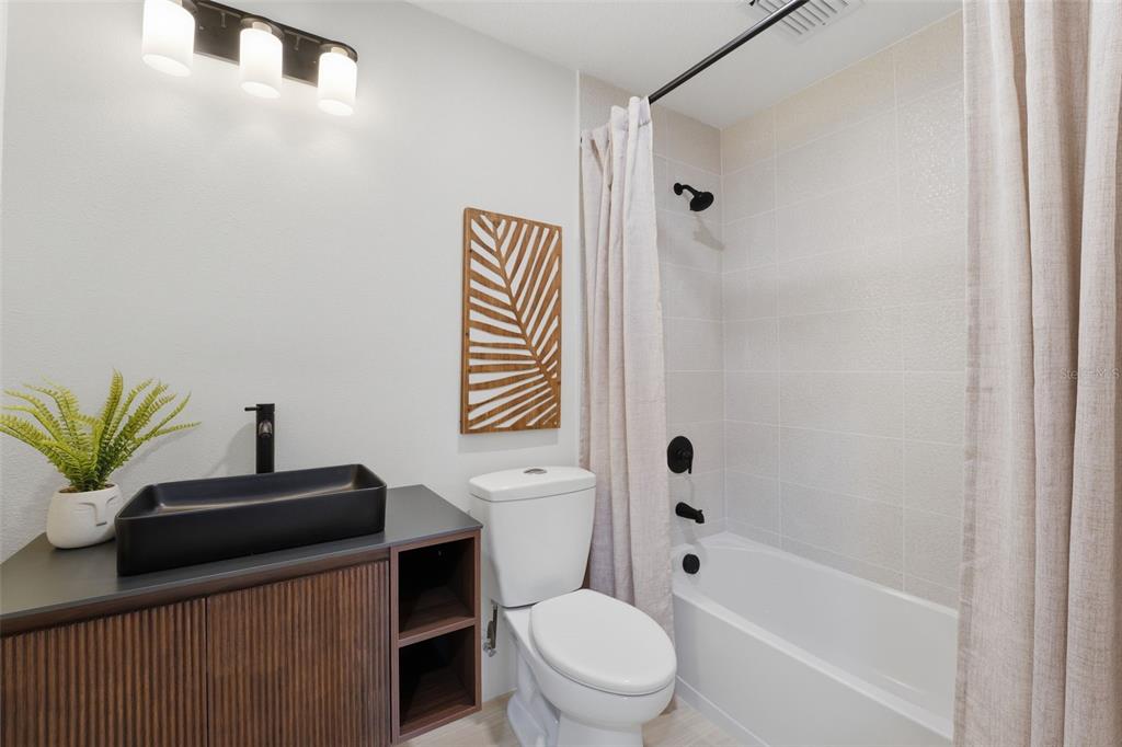 501 65th Street Holmes Beach, FL 34217 - Photo 40 of 61 a bathroom with a toilet a sink and a bathtub