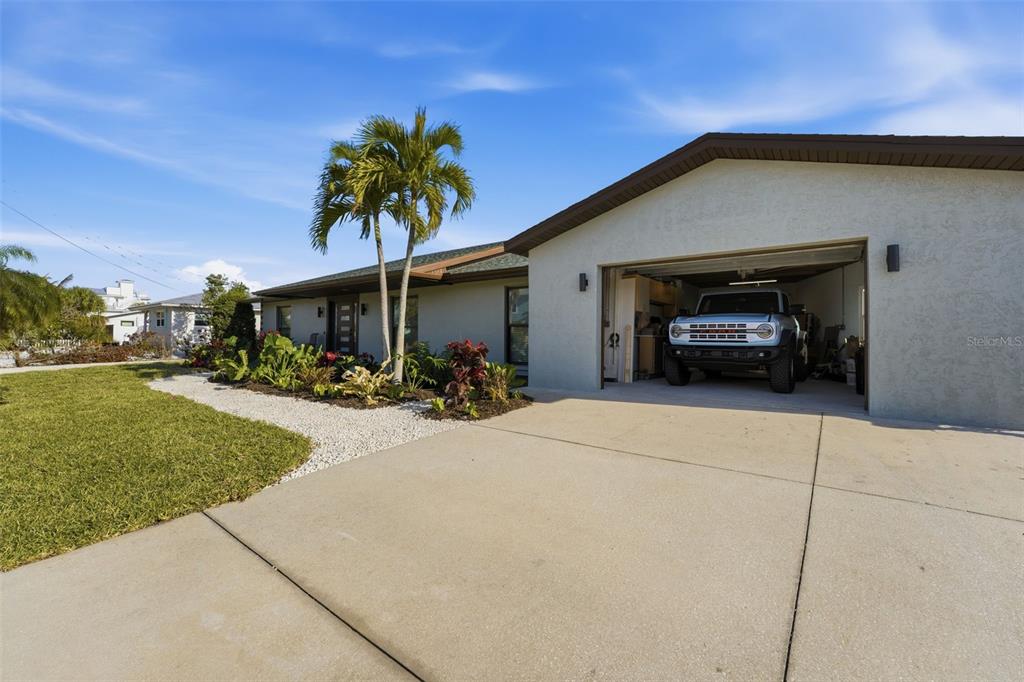 501 65th Street Holmes Beach, FL 34217 - Photo 43 of 61 a front view of a house with a yard