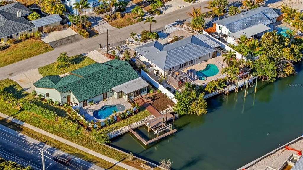 501 65th Street Holmes Beach, FL 34217 - Photo 53 of 61 an aerial view of residential houses with outdoor space and swimming pool