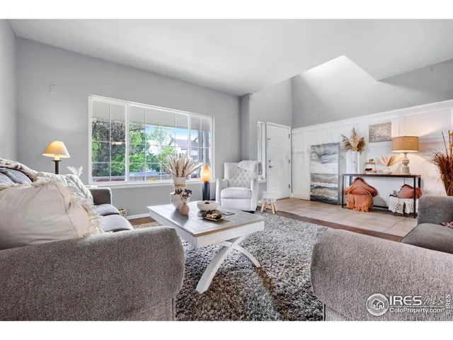 a living room with furniture a window and a table