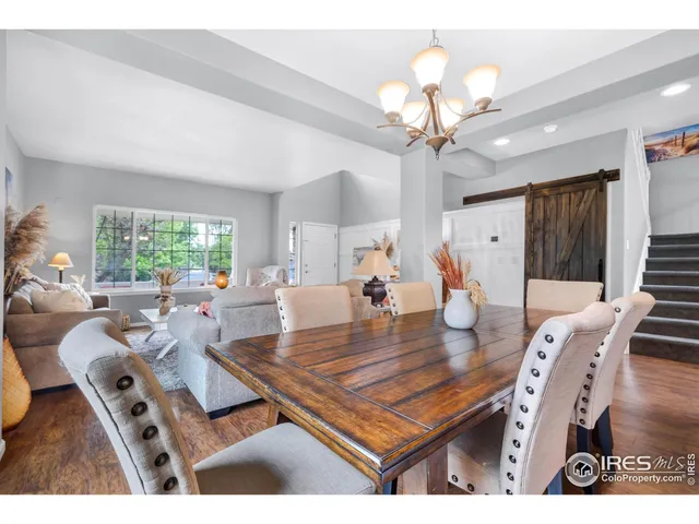 a living room with furniture a chandelier and a table