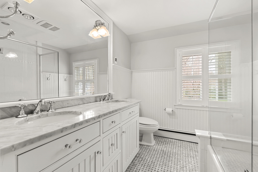 27 Radcliffe Road Wellesley, MA 02482 - Photo 23 of 38 a bathroom with a granite countertop sink a toilet a mirror and shower