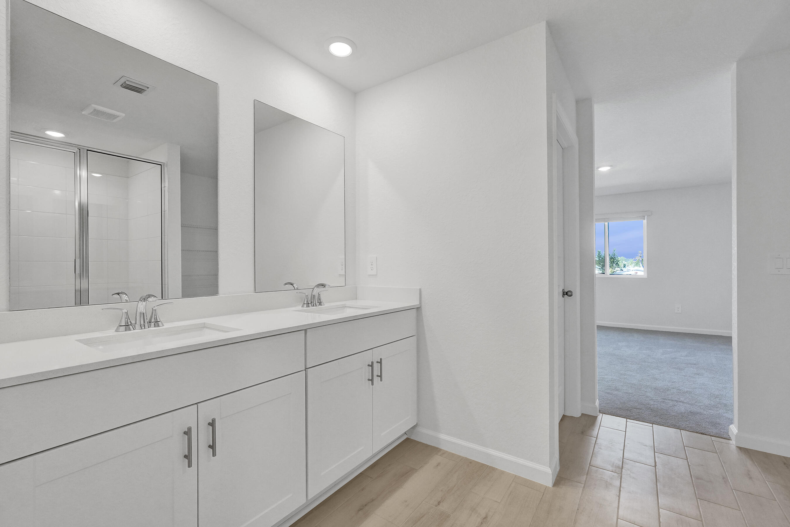 14308 Southwest New Dawn Road Indiantown, FL 34956 - Photo 11 of 25 a bathroom with a double vanity sink and mirror