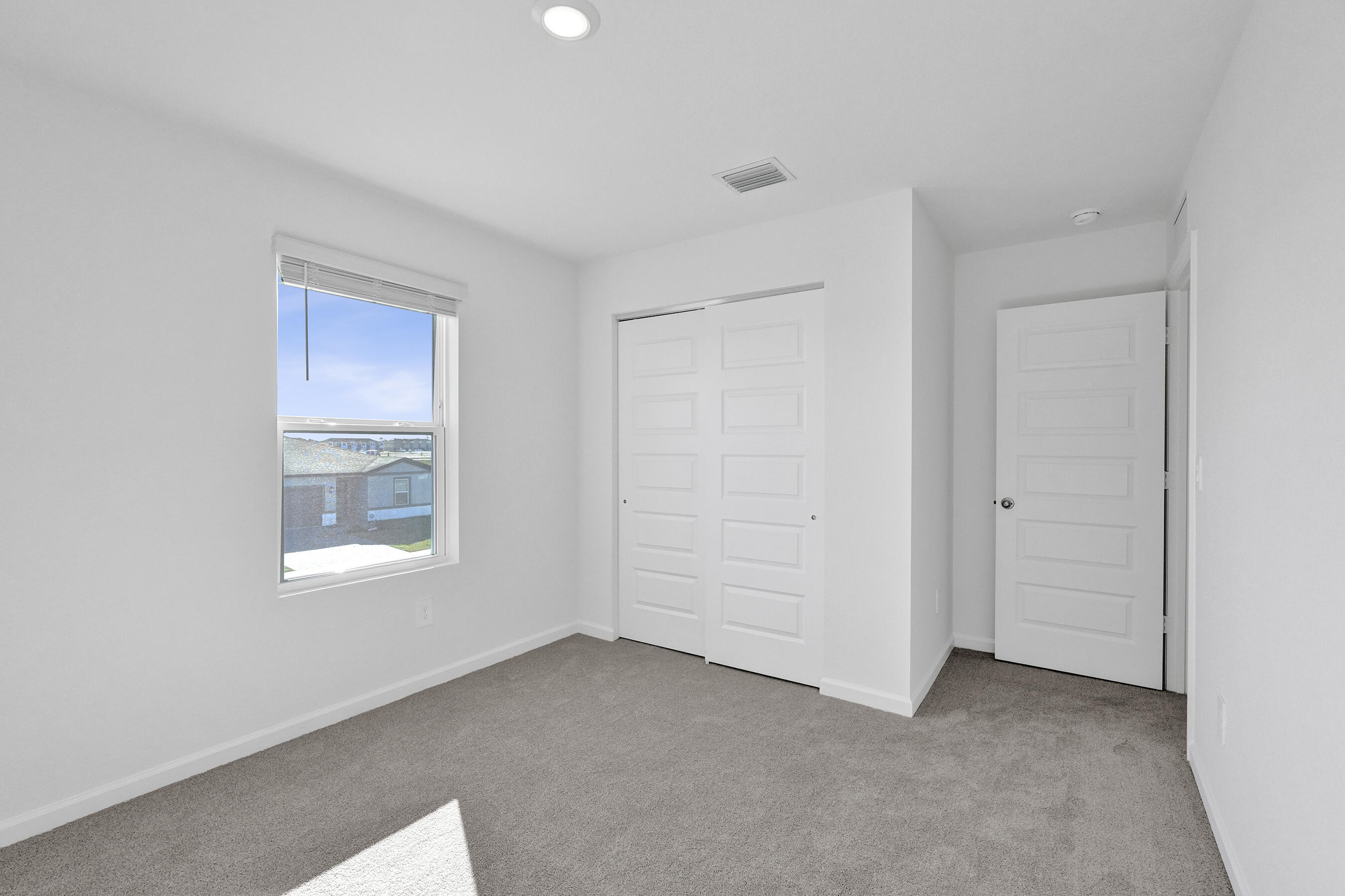 14308 Southwest New Dawn Road Indiantown, FL 34956 - Photo 16 of 25 a view of an empty room with a window
